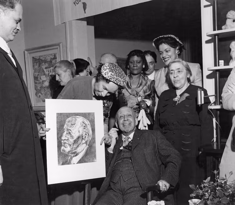 W.E.B Du Bois (center bottom), wife Shirley Graham Du Bois (center) and artist Bernard Goss (left) with his birthday portrait of Du Bois. (Courtesy of the Special Collections and University Archives, University of Massachusetts Amherst Libraries)
